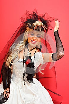 Laughing bride wearing net gloves and unusual hat