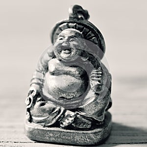 A laughing buddha in duotone