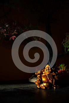 Laughing Buddha Statue on under the Tree. Statue of Laughing Buddha. Statue of kubera