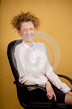 Laughing business woman sitting on the black chair