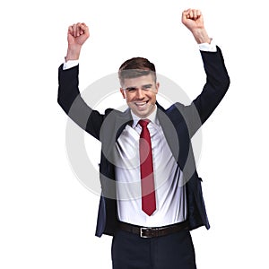 Laughing businessman celebrating success with fists in the air
