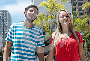 Laughing caucasian girl with hispanic boyfriend in the city