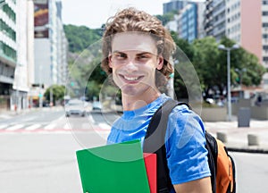 Laughing caucasian male student in city