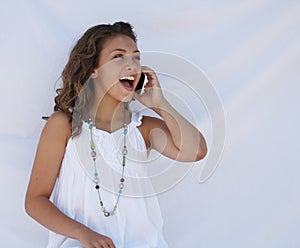 Laughing on cell phone.