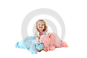 Laughing child holding toy poodles