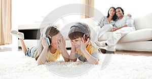 Laughing children listening music with headphones