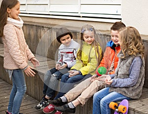 Laughing children playing with Ball on wooden platform