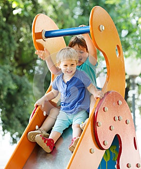 Laughing children on slide