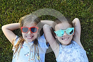 Laughing children wearing sunglasses relaxing during summer day