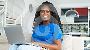 Laughing corpluent black female student learning at computer