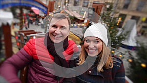 Laughing Couple Having Fun in the Attraction on the Christmas Market, Young Family Laughing in the Xmas Fair. Merry