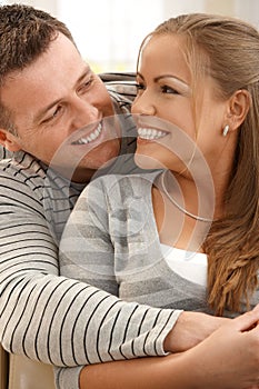 Laughing couple at home