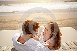 Laughing couple lying on sunbed