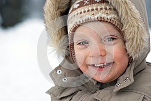 Laughing cute baby boy winter snow