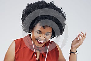 Laughing, dance or happy black woman in music headphones in studio for singing on grey background. Model, funny podcast