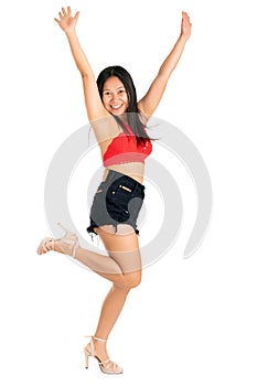 Laughing dancing young woman in a trendy outfit