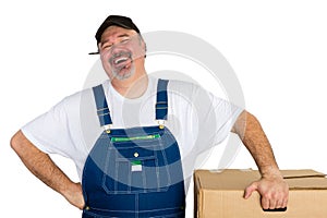 Laughing delivery man standing by big box