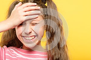 Laughing embarrassed girl cover forehead facepalm photo