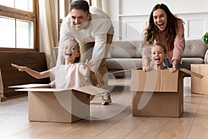 Laughing family couple having fun together with adorable daughters.