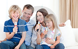 Laughing family singing together