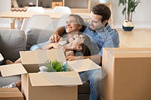 Laughing family spend time having fun at new home