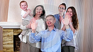 Laughing family waving their hands, all family members are having good time together, family idyll