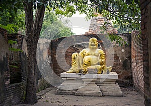 Laughing fat Buddha statue at Wat Phu Khao Thong in Ayutthaya. Thailand.
