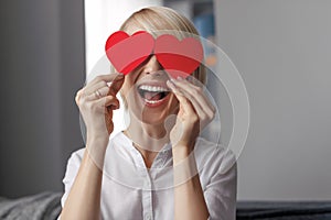 Laughing female with hearts near eyes