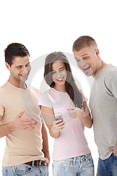 Laughing friends looking at mobile phone