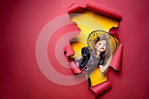 Laughing funny child girl in a witch costume in halloween