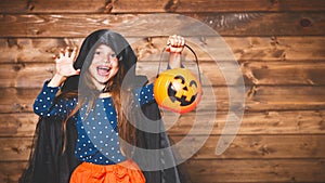 Funny child girl in witch costume in halloween