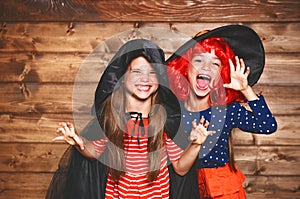 Funny children sister twins girl in witch costume in halloween