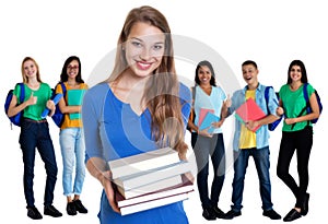 Laughing german female student with books and group of students