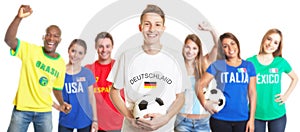 Laughing german soccer with blond hair with fans from other countries