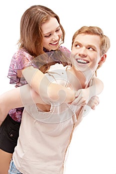 Laughing girl astride young man