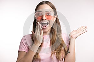 Laughing girl closing her mouth with a hand