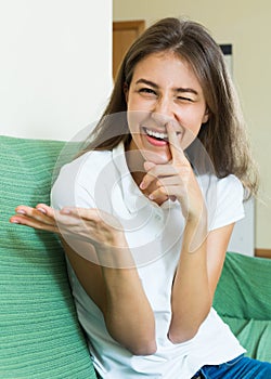 Laughing girl with finger in nose