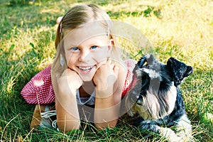 Laughing girl and her trusty miniature schnauzer photo