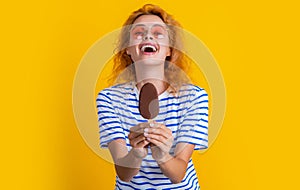 laughing girl with icelolly ice cream in studio. girl with icelolly ice cream on background. photo