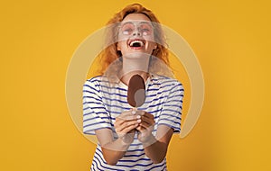 laughing girl with icelolly ice cream in studio. girl with icelolly ice cream on background. photo