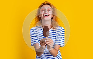 laughing girl with icelolly ice cream in studio. girl with icelolly ice cream on background.