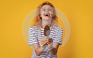 laughing girl with icelolly ice cream in studio. girl with icelolly ice cream on background.
