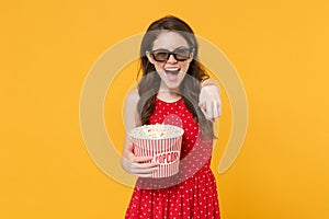 Laughing girl in red summer dress, 3d glasses isolated on yellow background. People lifestyle concept. Mock up copy