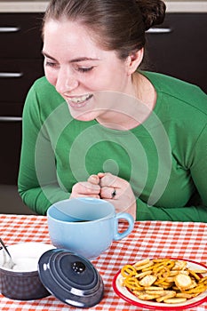 Laughing girl sitting at the table