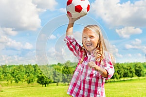 Laughing girl throwing ball