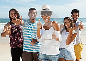 Laughing group of multiethnic man and women at beach