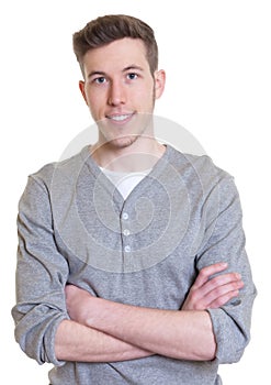 Laughing guy with crossed arms in a grey shirt