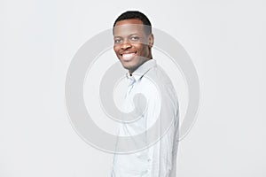 Laughing handsome young african man in shirt smiling confident