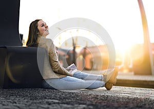 Laughing and happy woman waiting train at station.