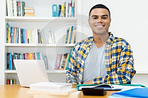 Laughing hispanic computer science student with braces